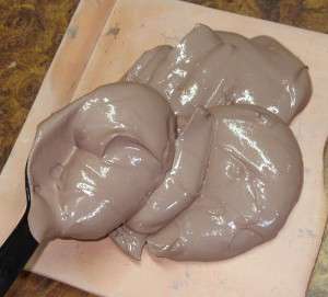 scooping clay onto an absorbent surface
